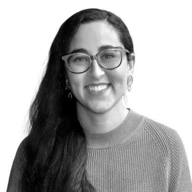 The image shows a person with long, dark hair wearing a knit sweater.AI-generated content may be incorrect.